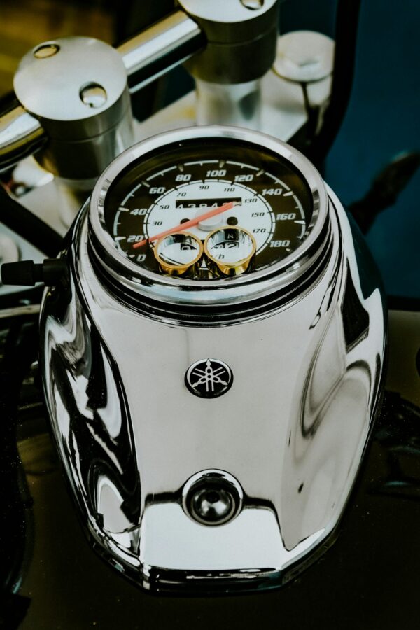 From above fancy golden wedding rings placed on contemporary powerful motorbike speedometer for proposal