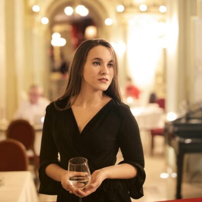 Woman in Black Long Sleeve Holding Champagne Glass